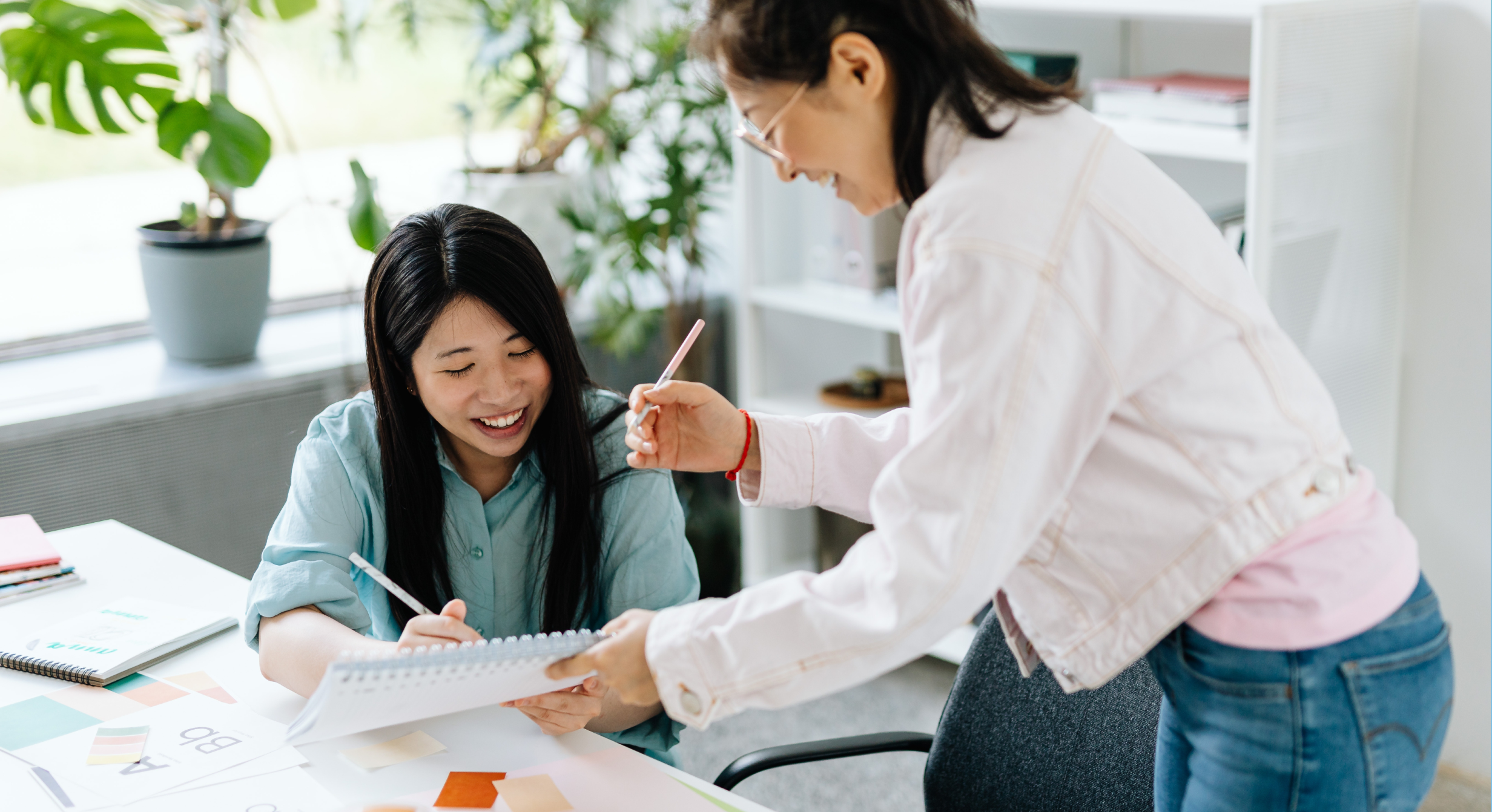 Image of two workers working together on a project. 