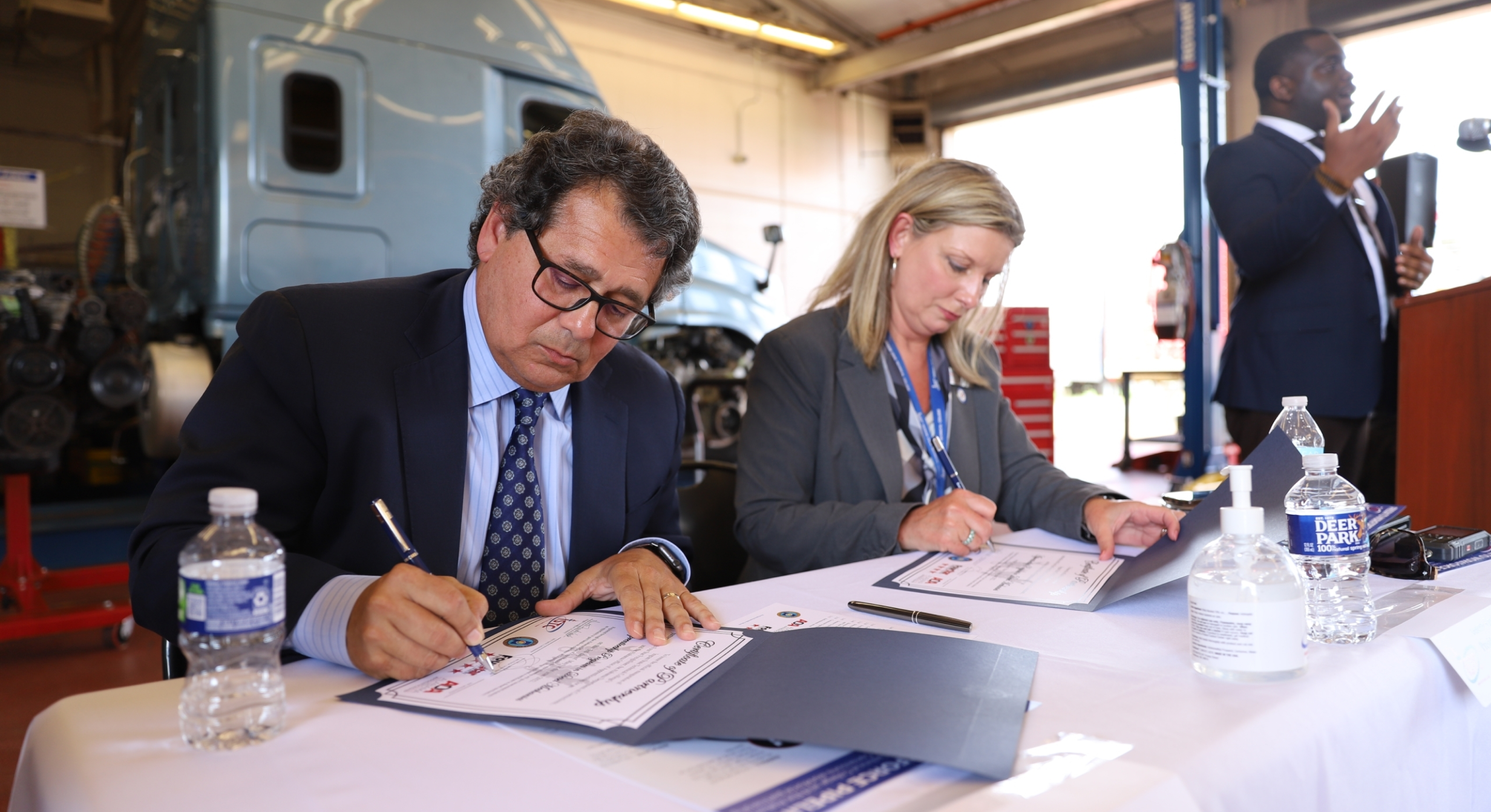 Four Star Freightliner executives signing the apprenticeship program partnership. 
