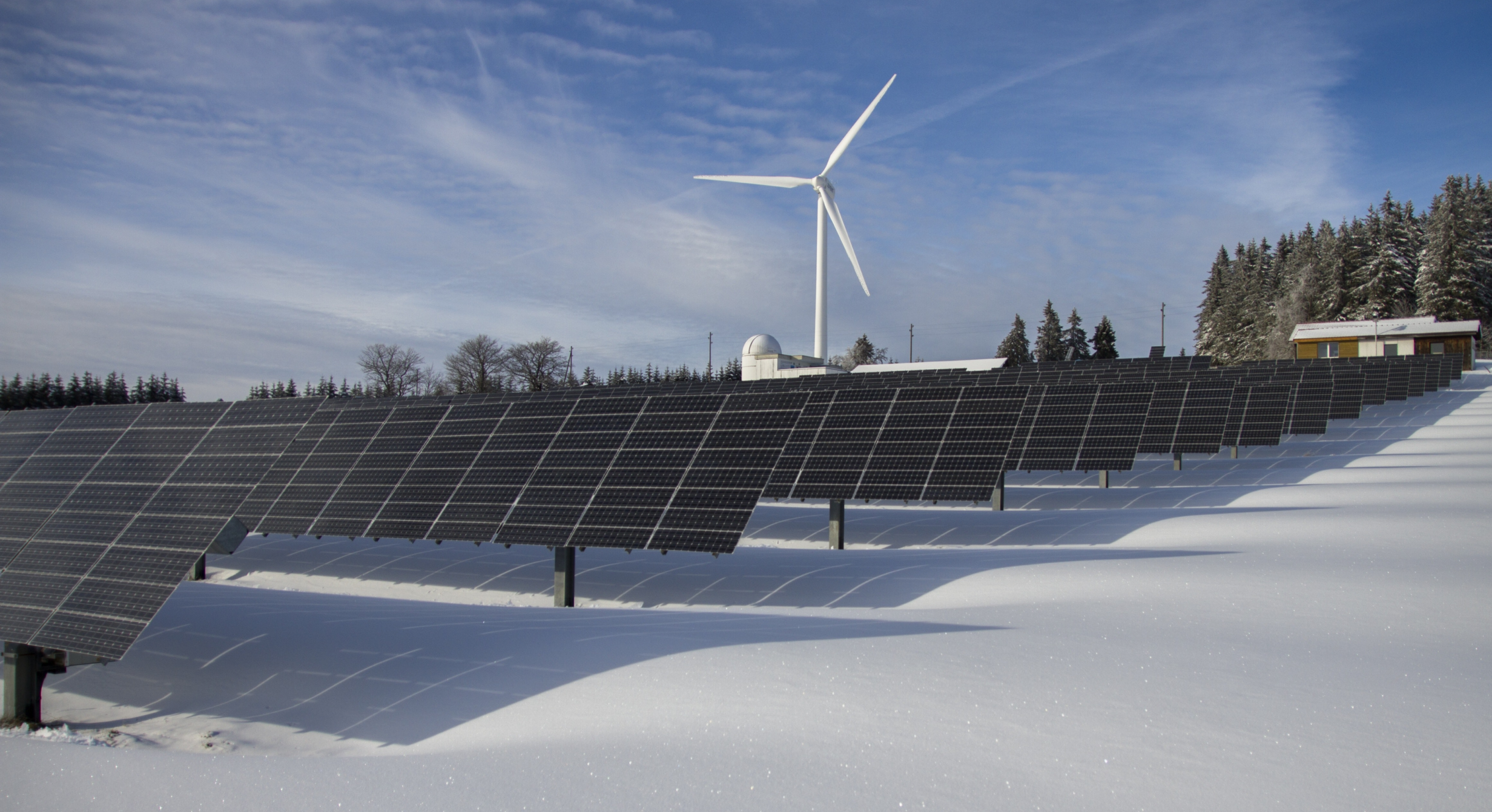 Image of solar panels and wind turbines. 