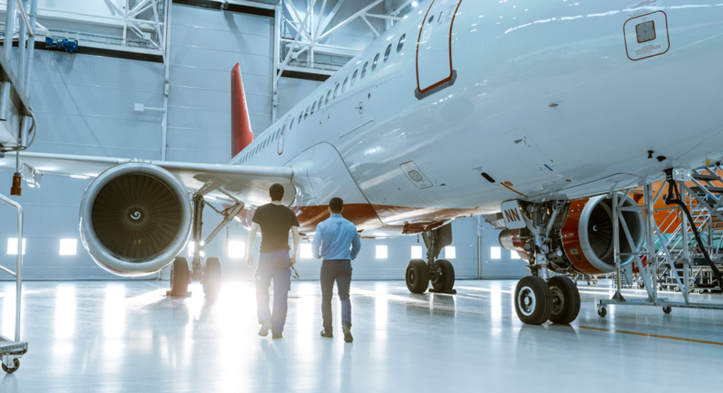 Image of manufacturing workers looking over an aircraft. 