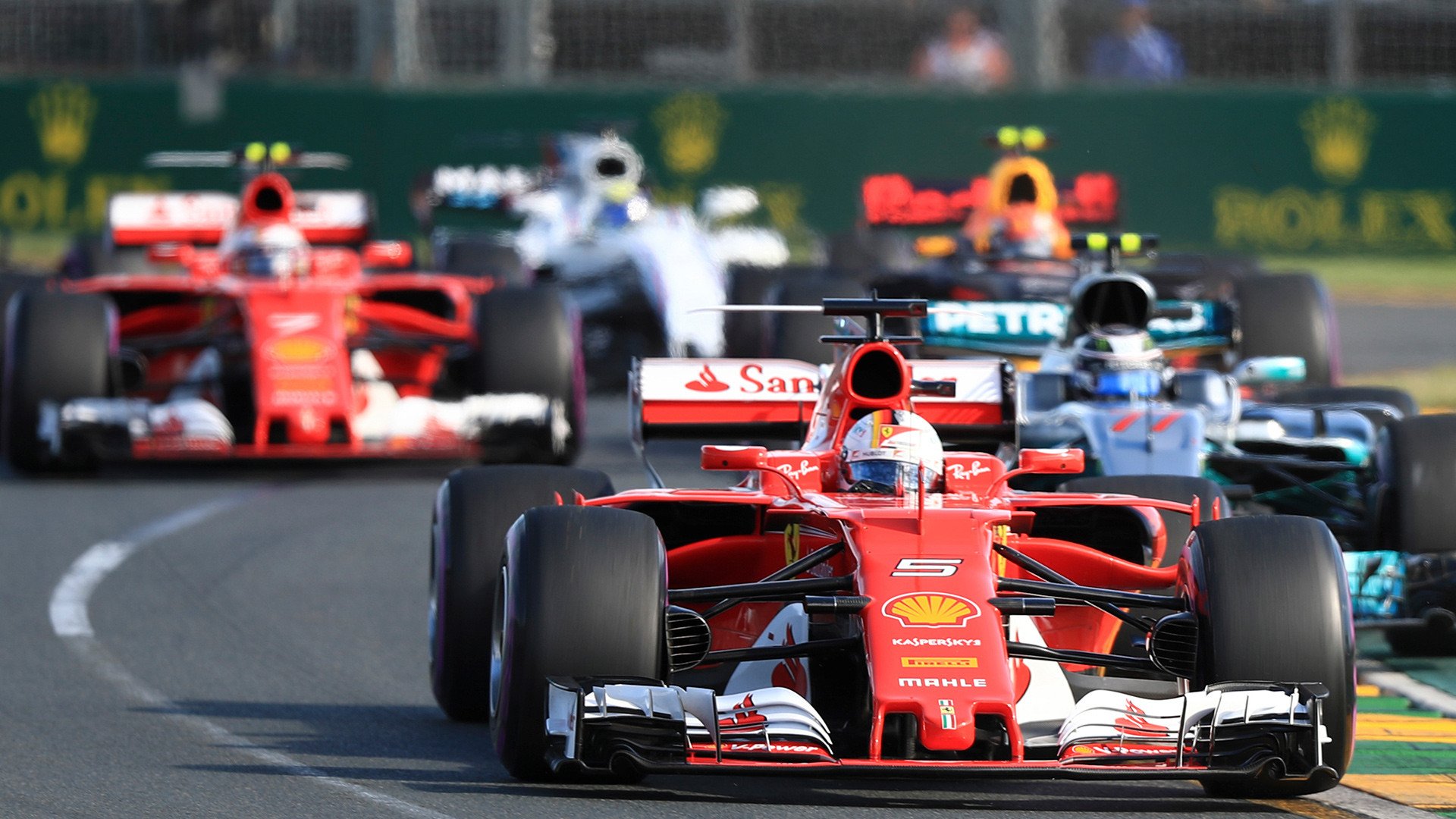 Image of a formula one race in action. 